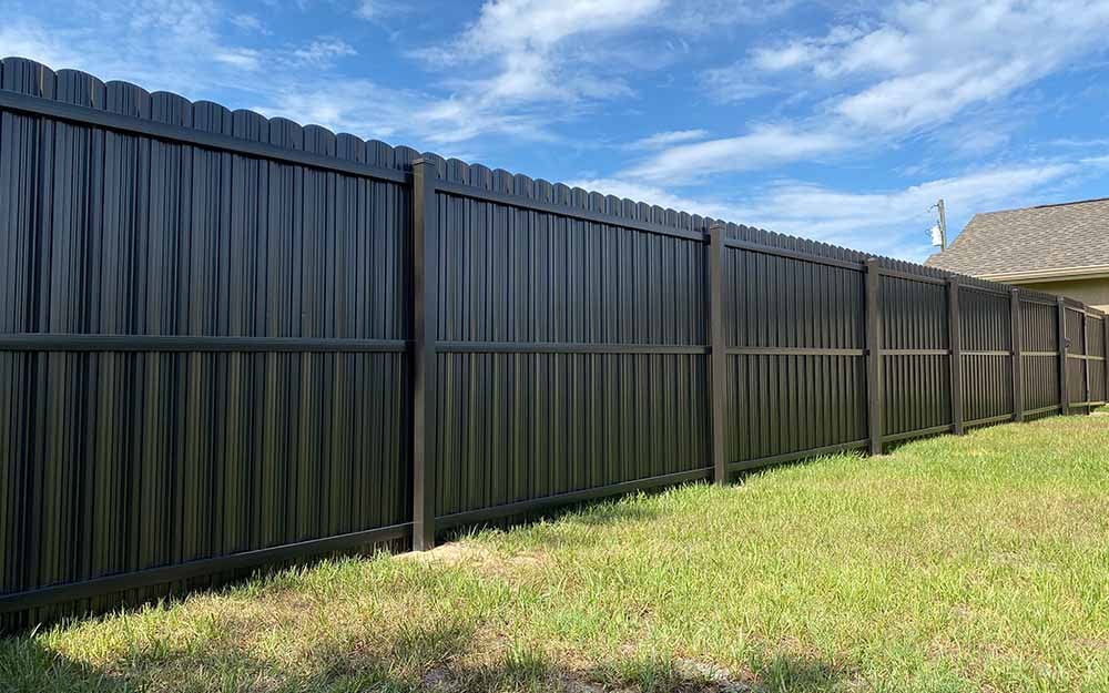 Black Dura Fence privacy panels installed along a Florida backyard